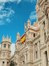 yellow and red flag hanging on white building