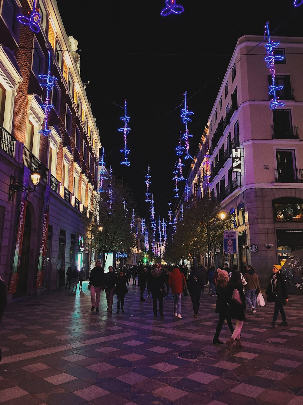 people walking on street at night