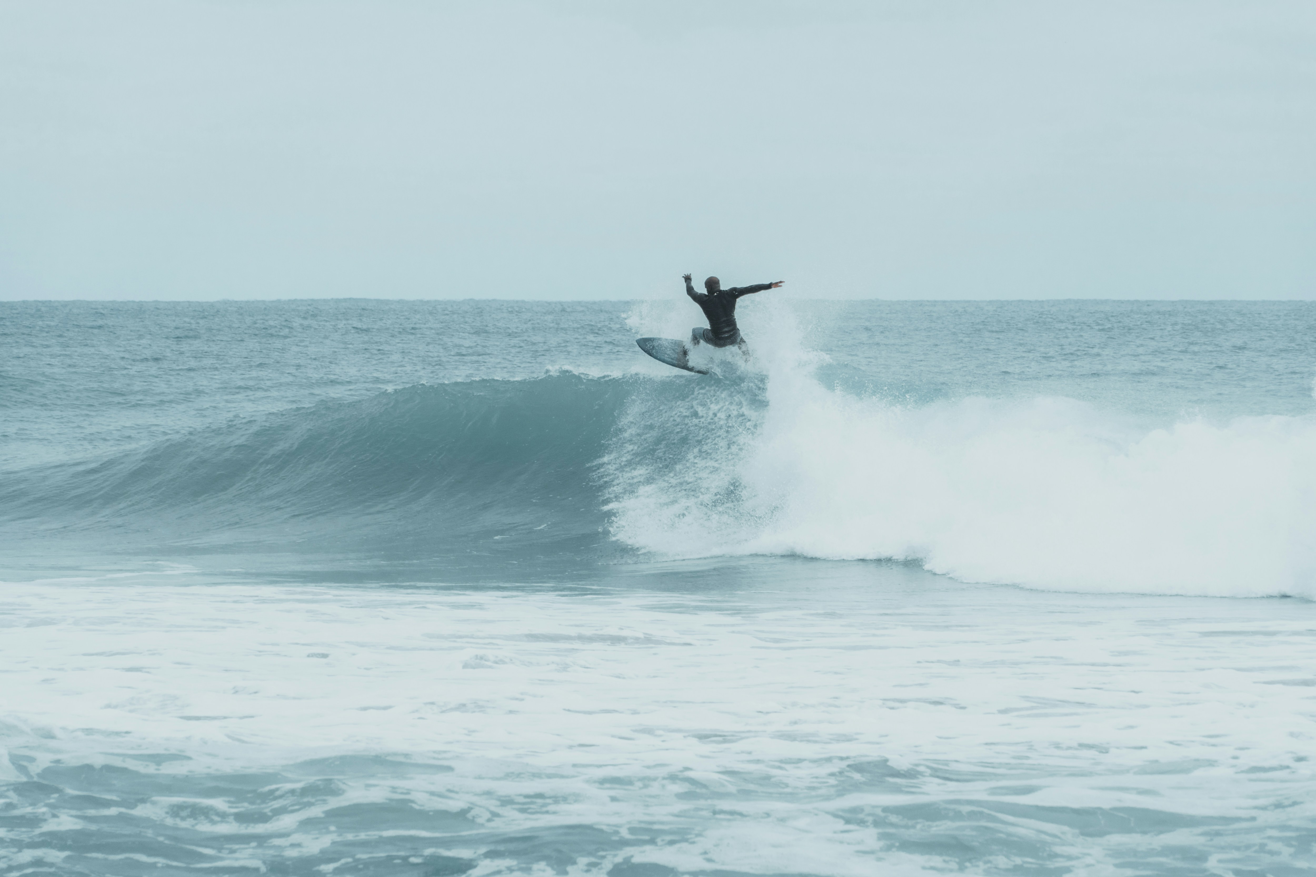 person surfboarding on wave