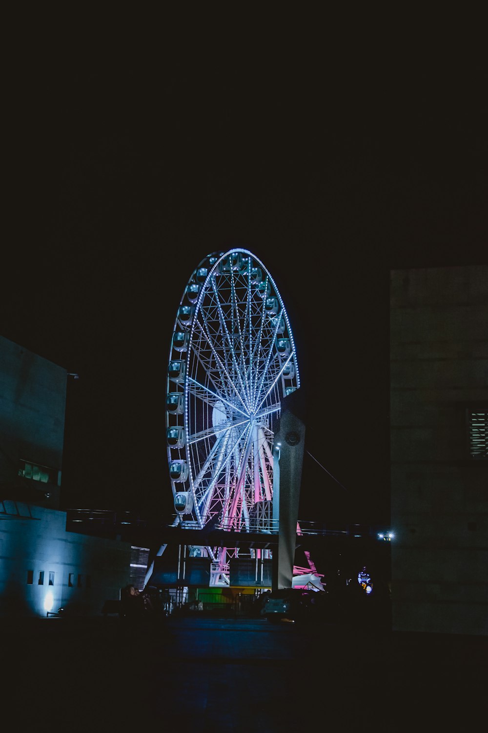 Rueda de la fortuna iluminada de azul durante la noche