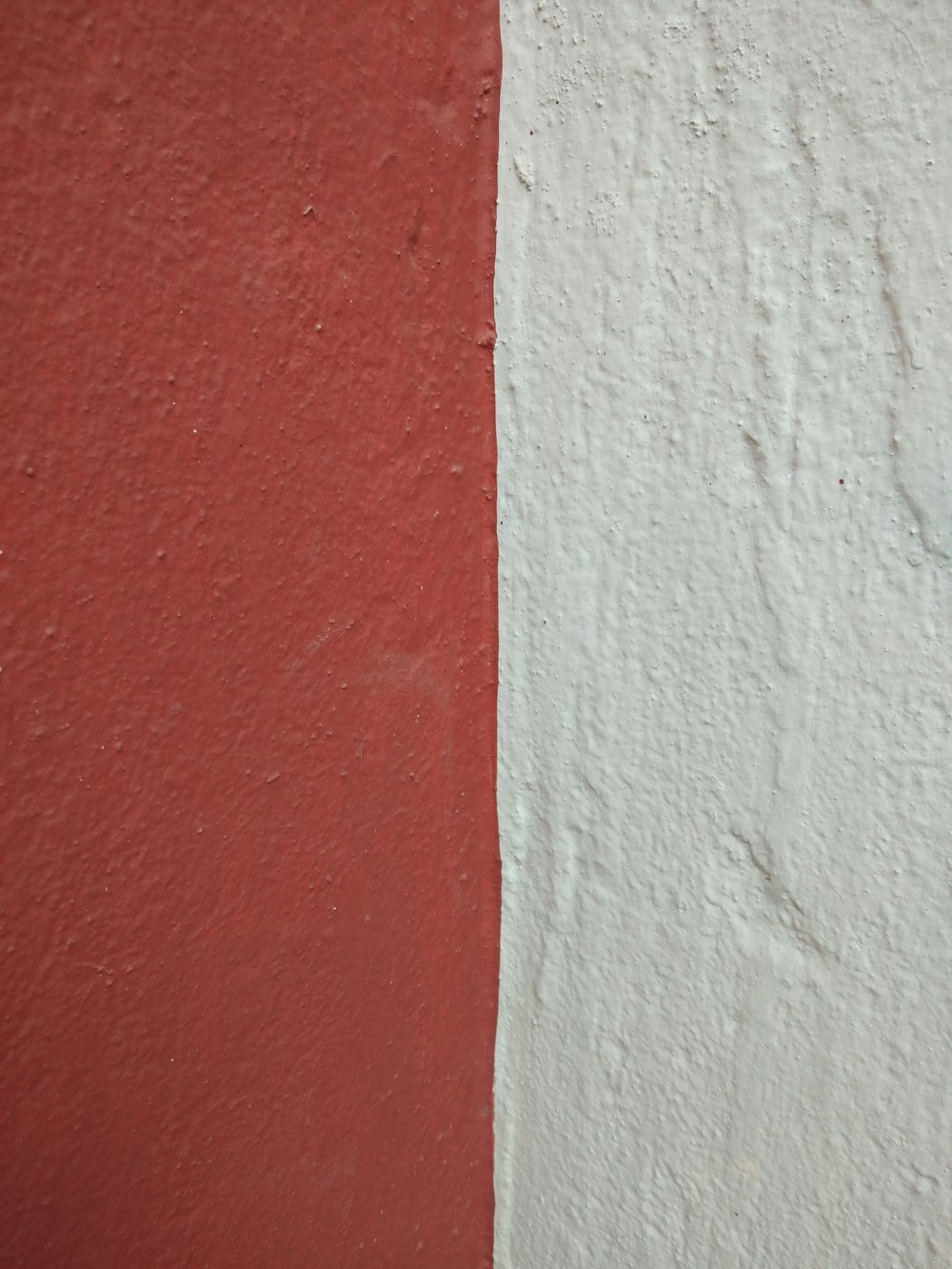 a red and white wall with a white stripe