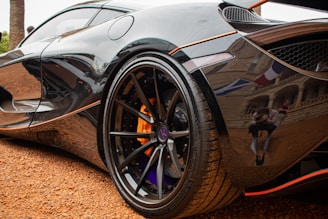 Photographer taking detailed pictures of a vehicle used as collateral in a bank field visit.