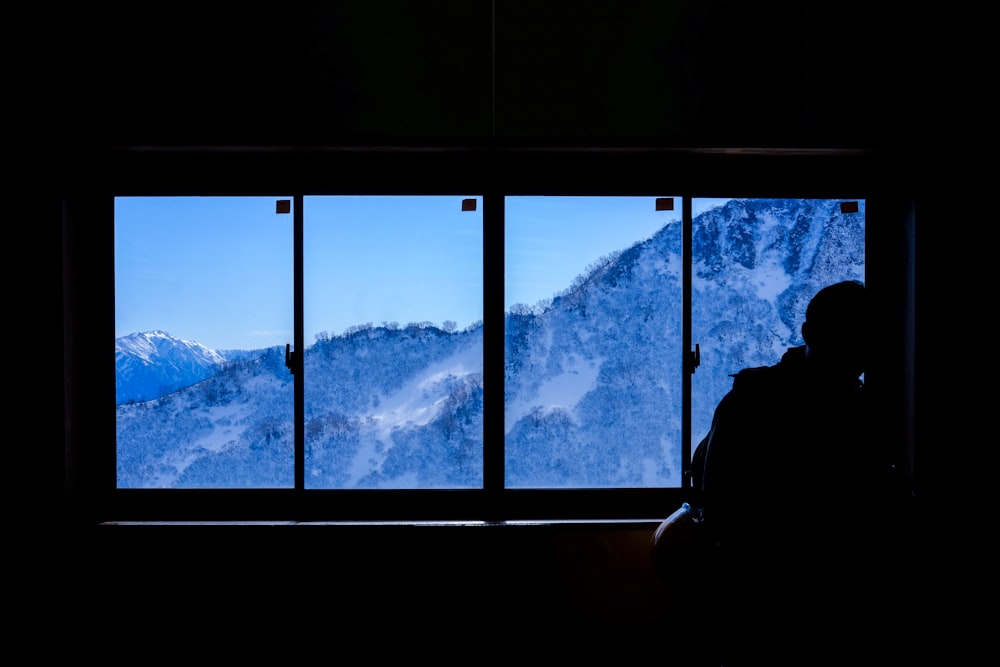 person sitting beside window