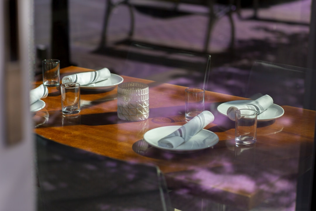 white table napkins on plates, Window shots of empty tables.