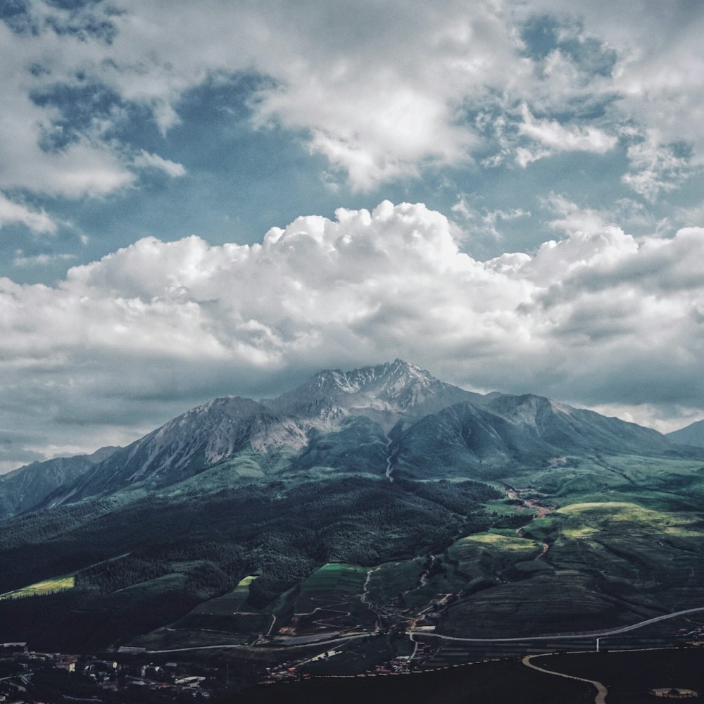 rocky mountain under cloudy sky during daytime