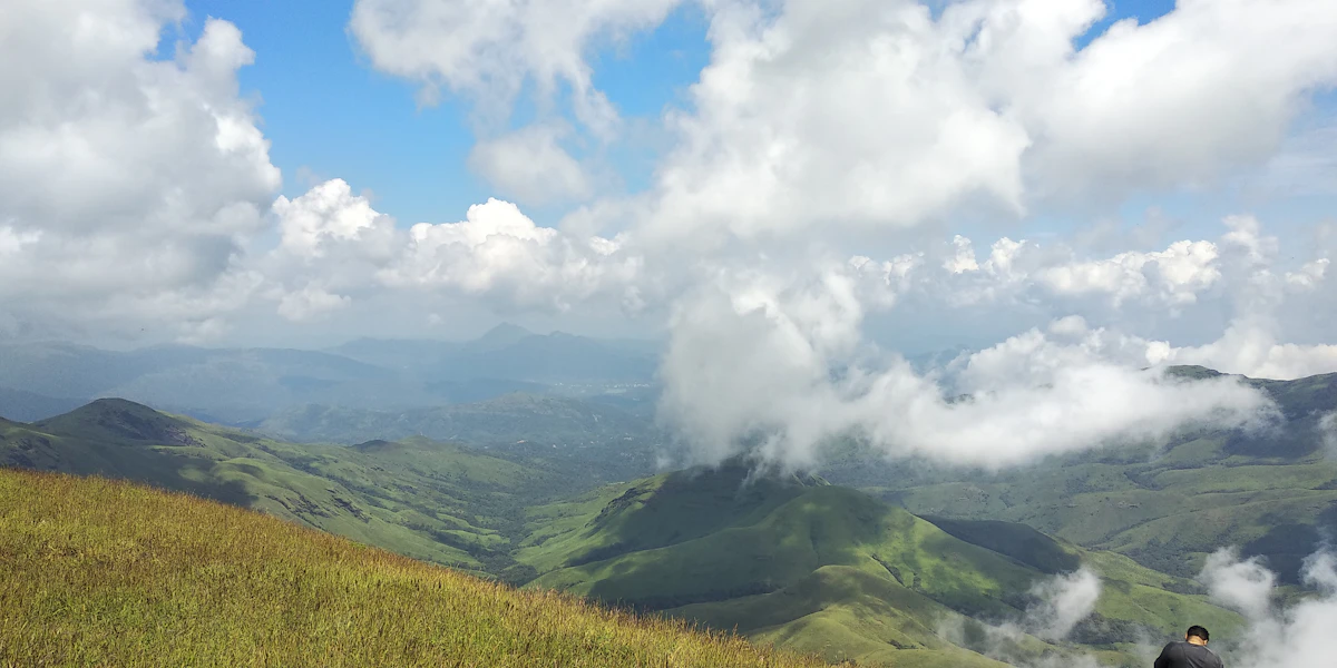 Rolling green shola grassland ridges and peaks in Kudremukh National Park