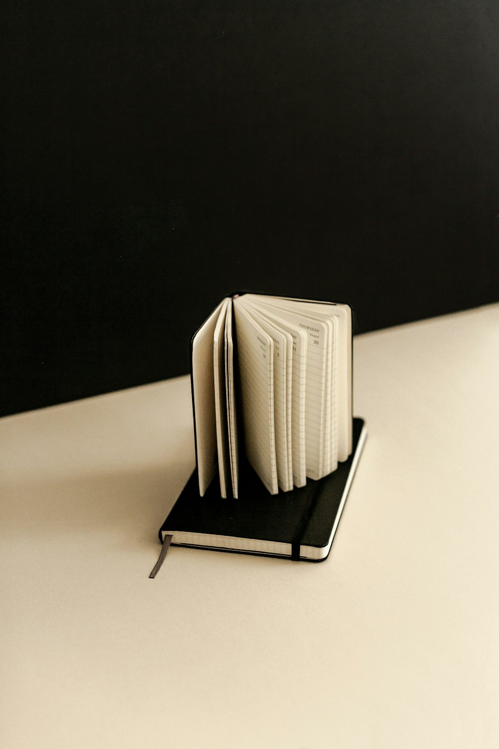 a stack of books sitting on top of a black and white book