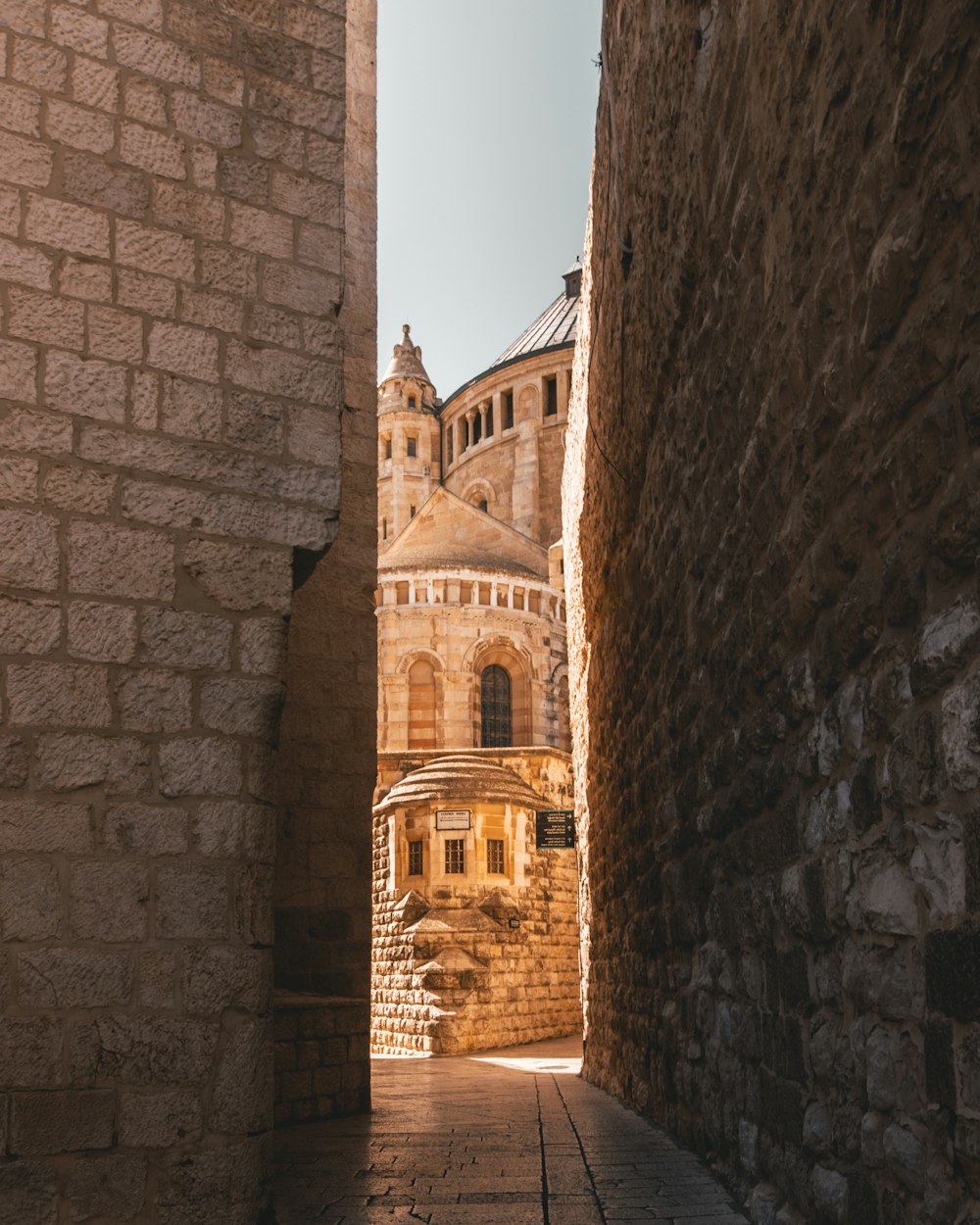 pathway in between of bricked buildings through castle
