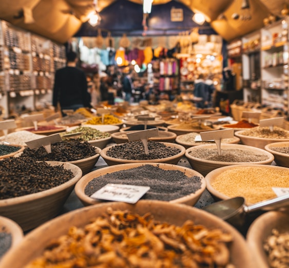 people walking beside pot of grains