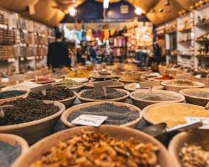 A bustling local market scene filled with colorful spices and smiling faces.