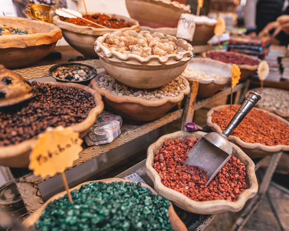 assorted spices in bowls on display stand