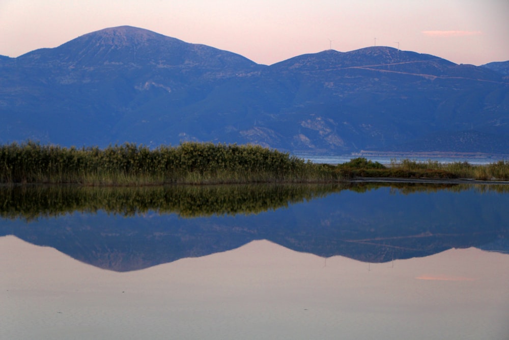 silhouette of mountains near body of water