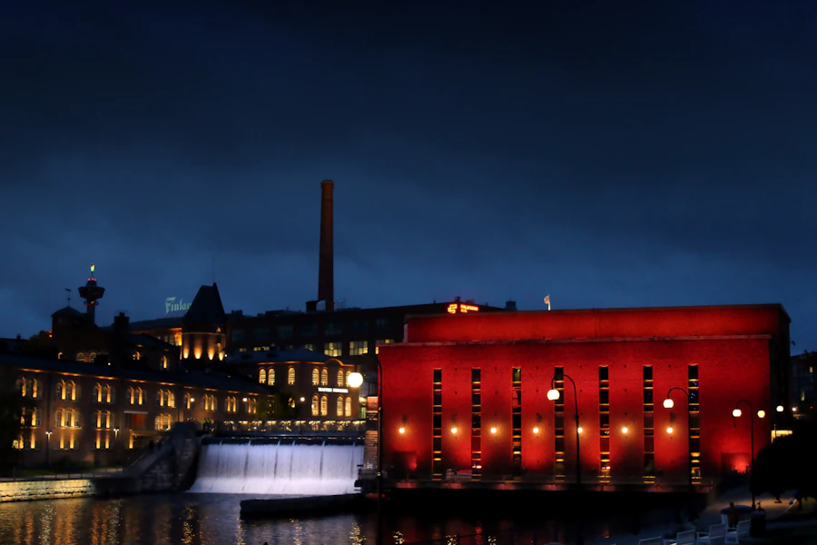 Tammerkoski and illuminated brick buildings in Tampere