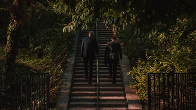 shallow focus photo of person walk up stairs during daytime