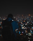 A cityscape backdrop with a model wearing a trendy Papilora backpack against an evening skyline.