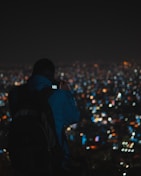 A cityscape backdrop with a model wearing a trendy Papilora backpack against an evening skyline.