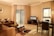 A clean and inviting living room with fresh linens and well-arranged furniture.
