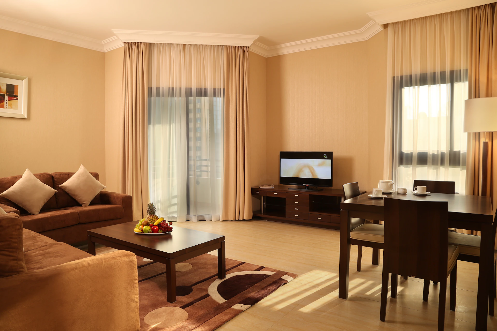 Real photograph of a furnished living room in Abu Dhabi. Illustrative interior, not the advertised unit.