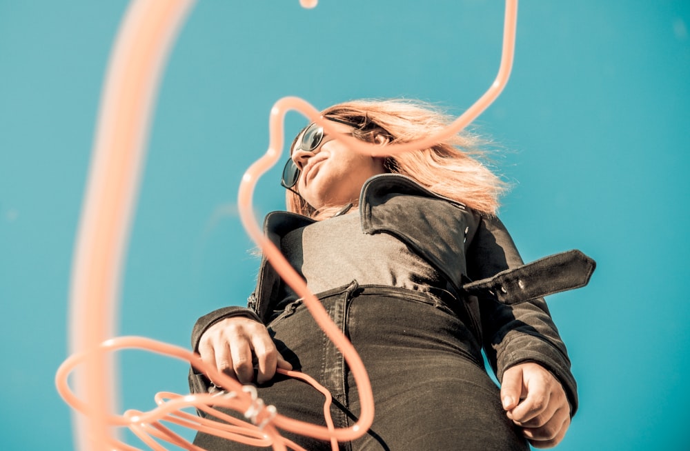 low-angle photography of woman in black leather jacket