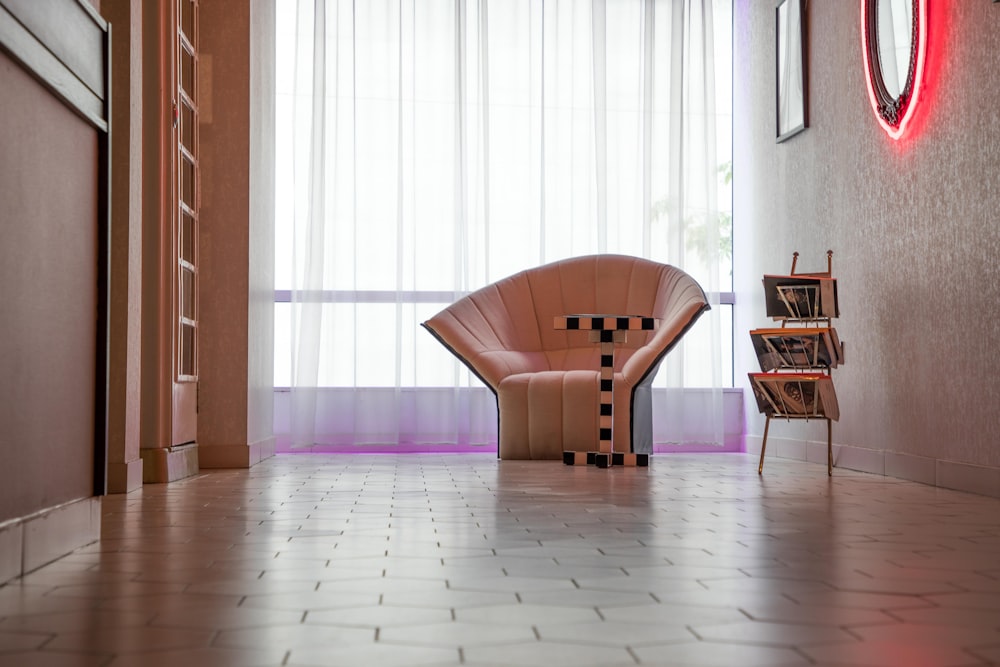 white sofa chair and white window curtain