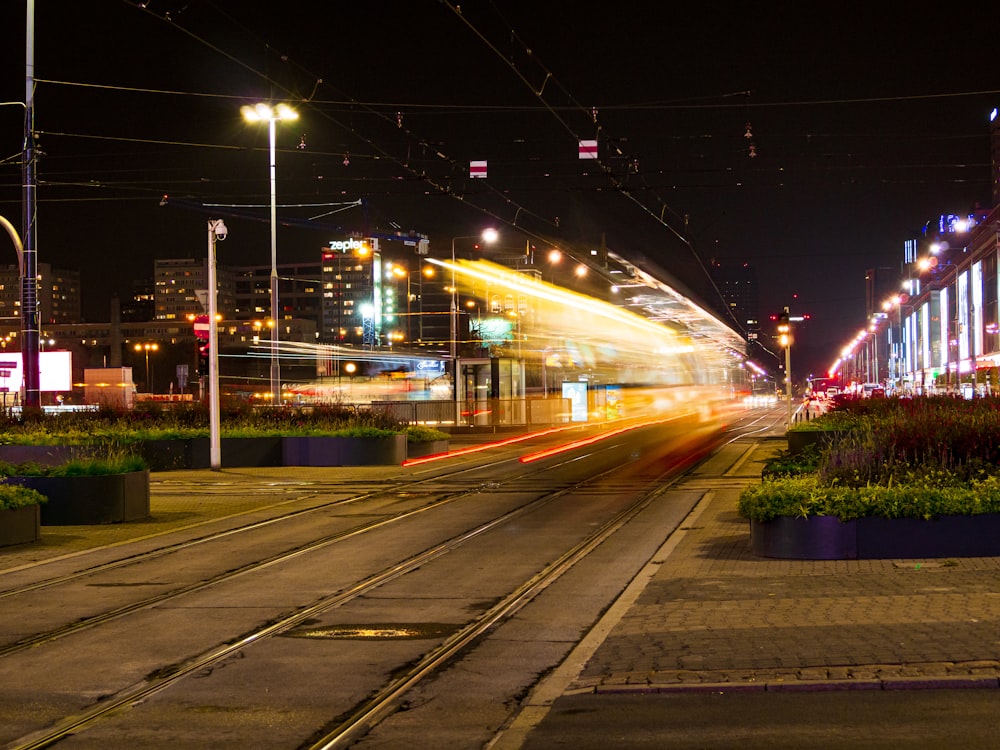 buildings, road, and lampposts during night