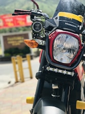 Close-up of hands signing a credit agreement with a motorcycle in the background.