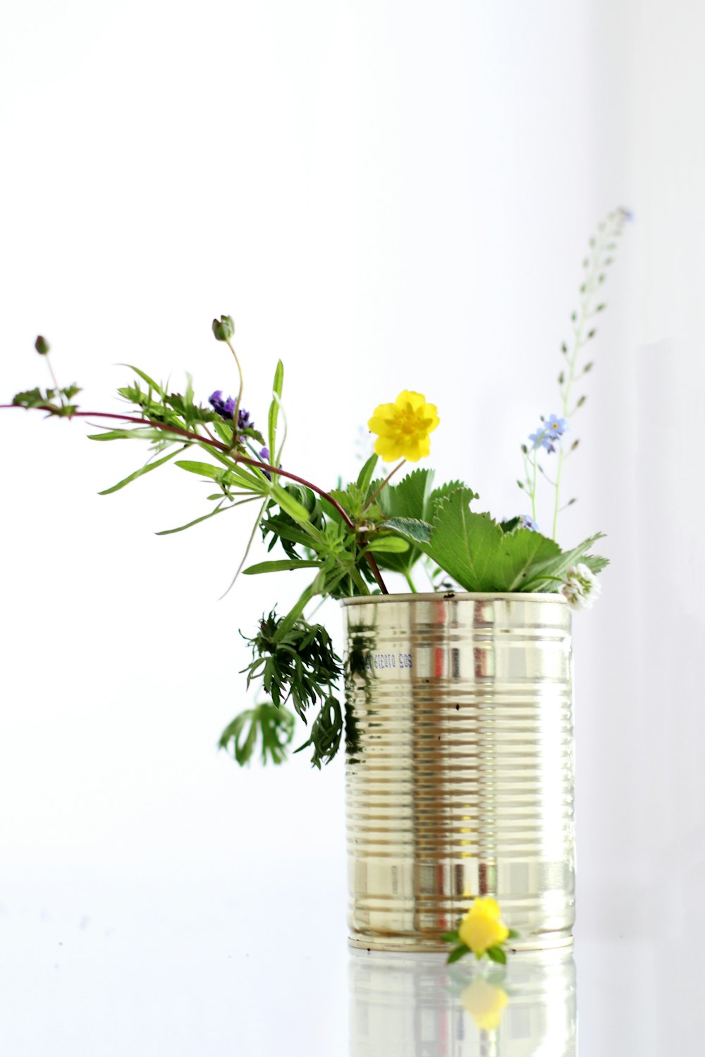 yellow petaled flower in the stainless steel can