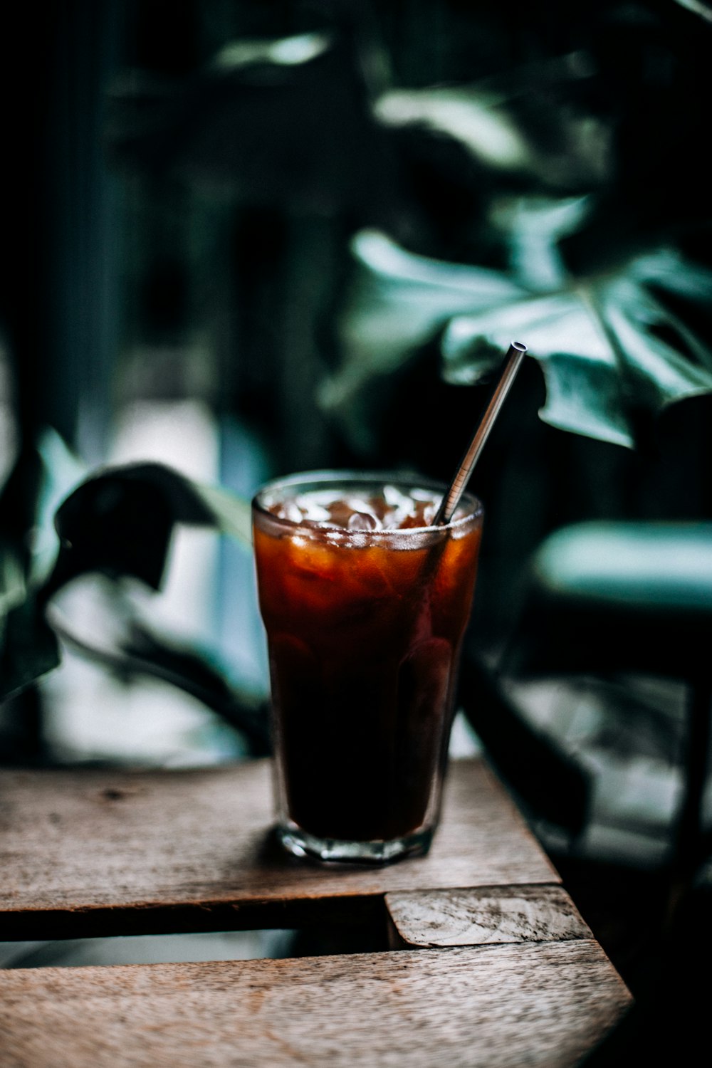 drinking glass filled with brown liquid