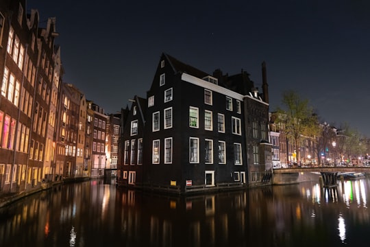 reflection of black house facing body of water at night in Cafe Aen't Water Netherlands