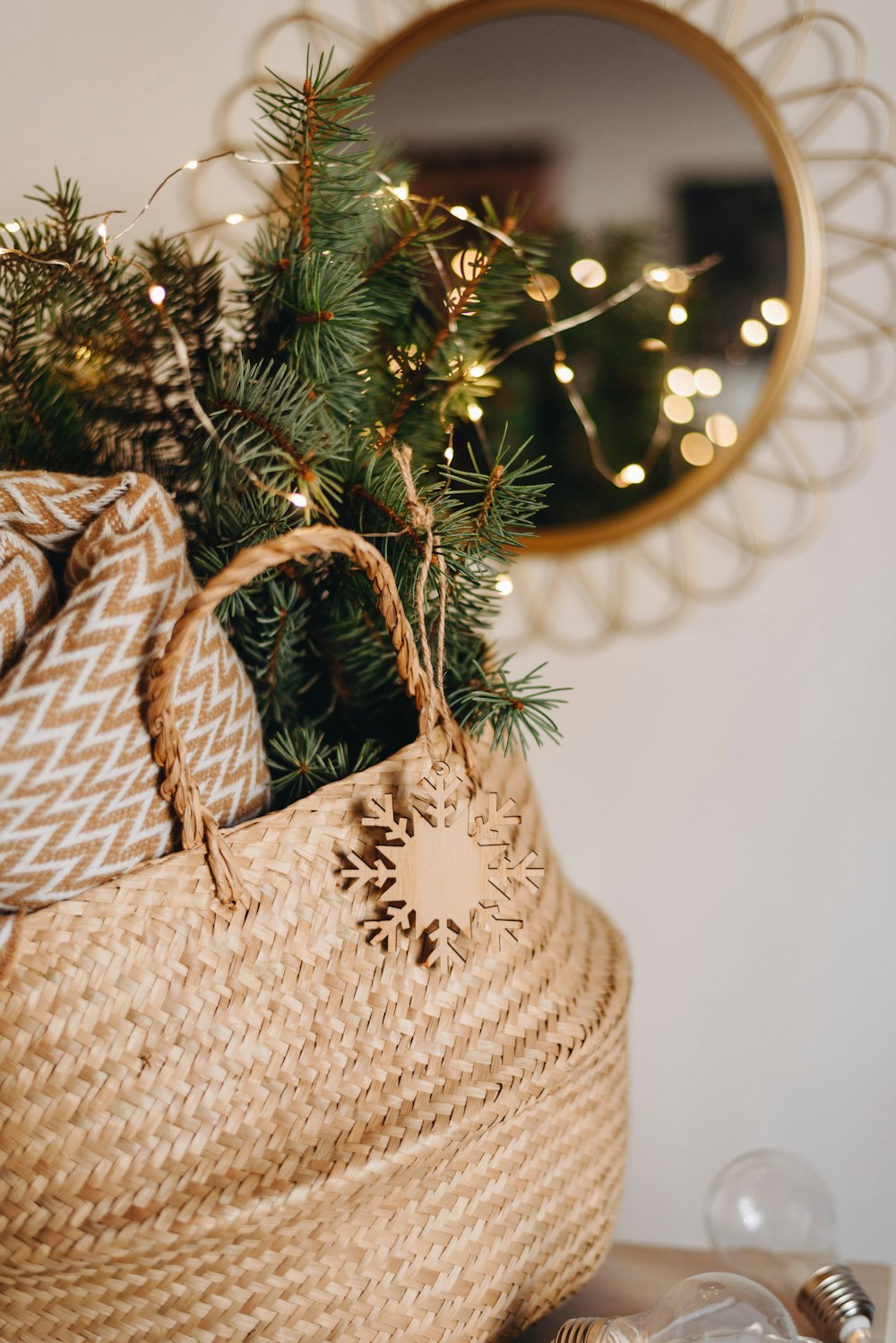 brown woven basket with garlands and blanket