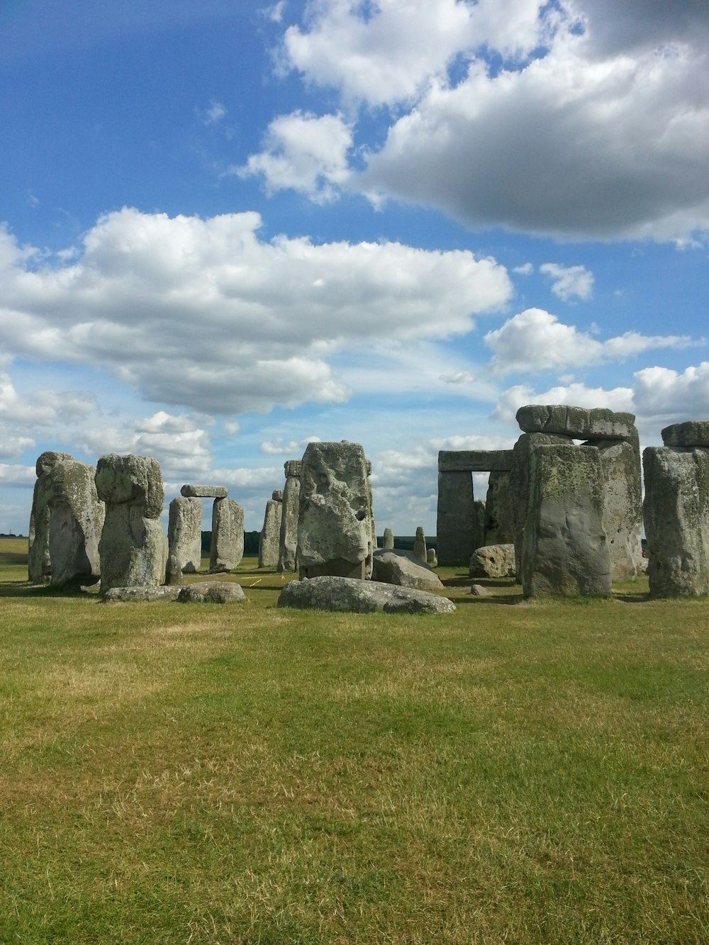 gray stones on grass fields during daytime