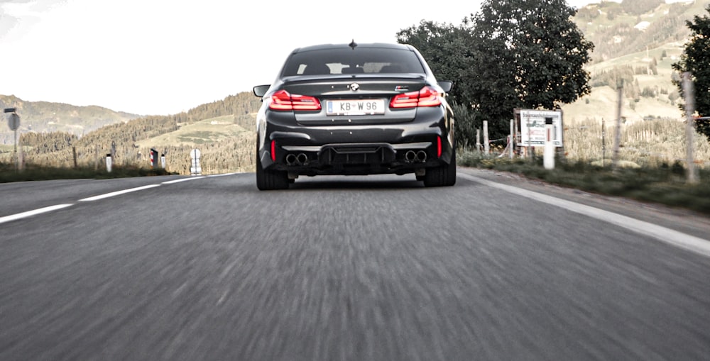 black BMW car on road during daytime