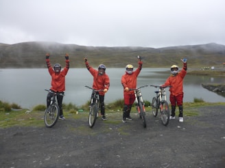 Bikers celebrating after completing a race, full of joy.