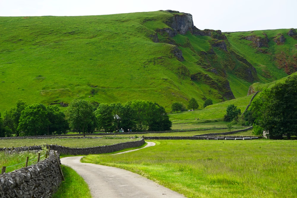 view photography of green mountain near road during daytime