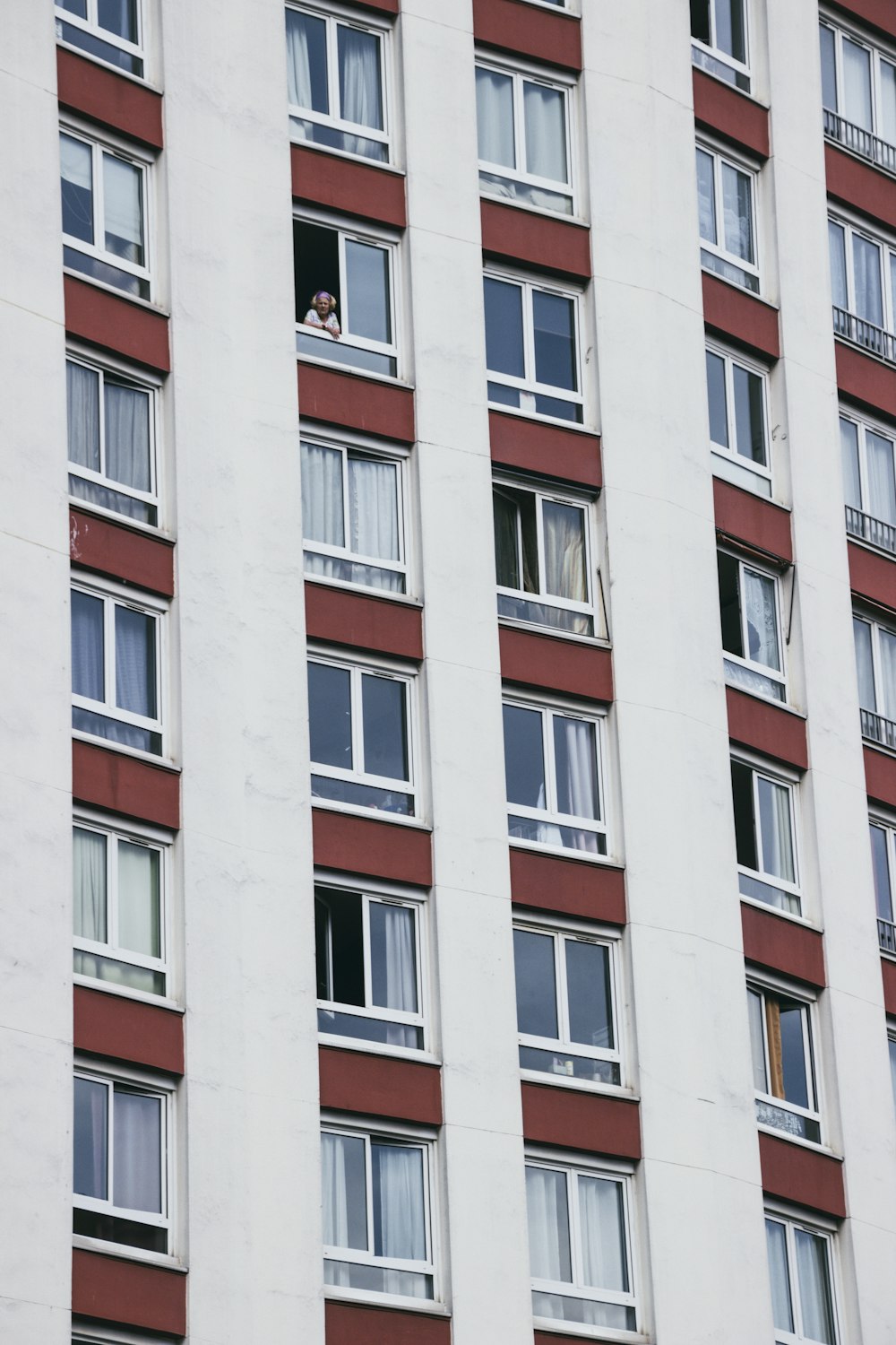 white and red concrete high-rise building daytime