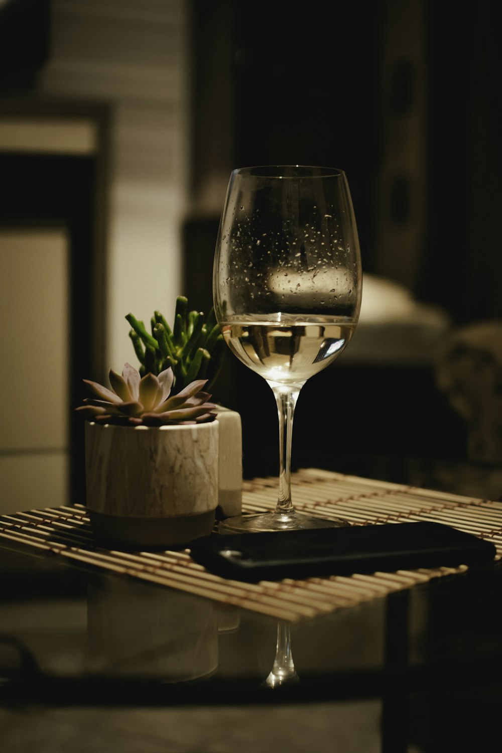 a glass of wine sitting on top of a table