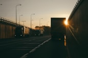 vehicles parked at roadside during golden hour
