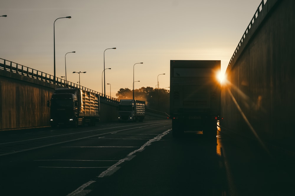 vehicles parked at roadside during golden hour