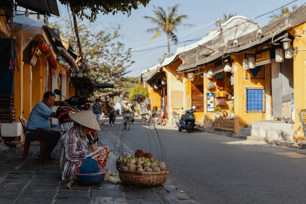 woman sitting in front of displayed basket beside road