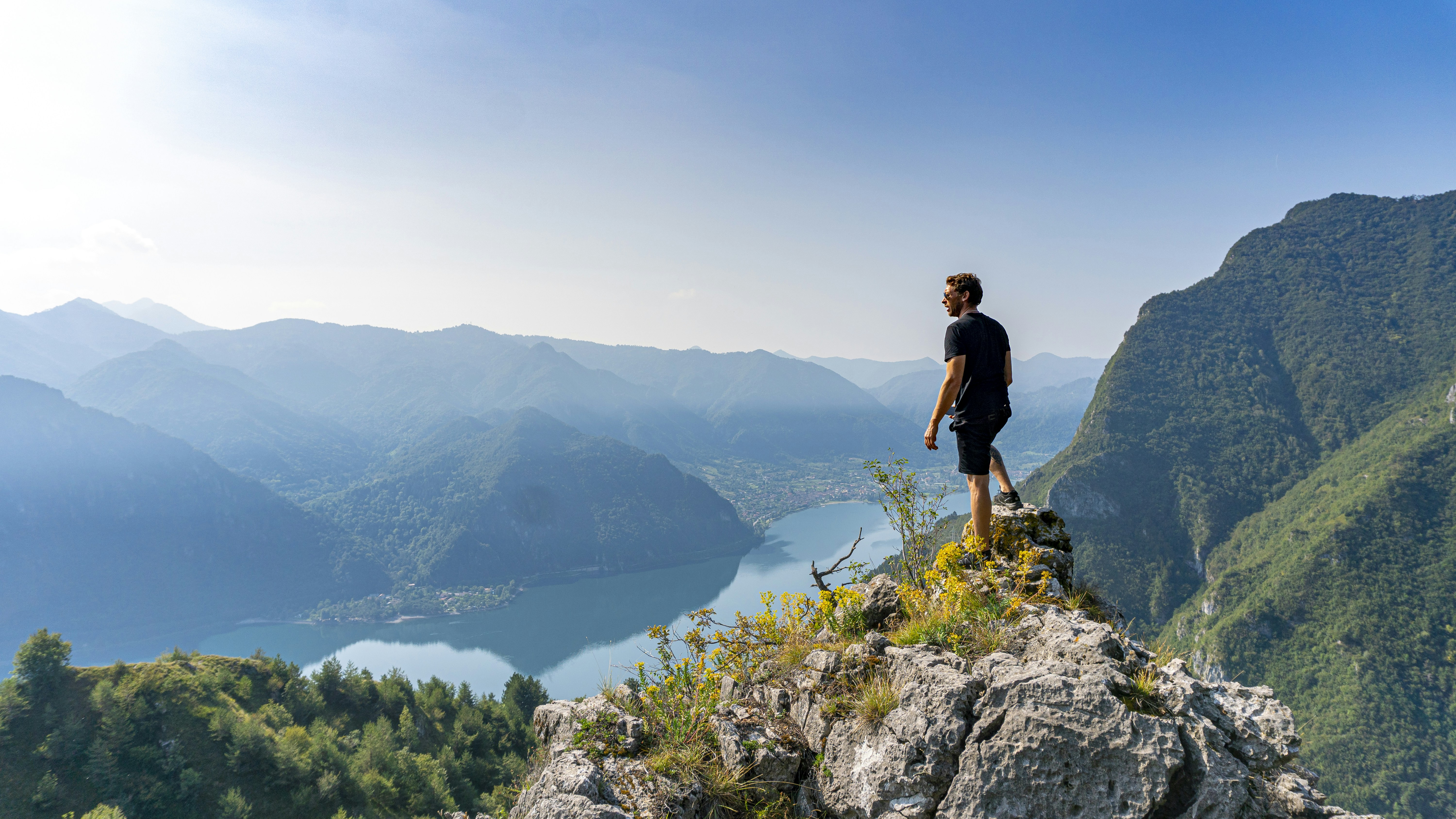 man standing on boulder during daytime