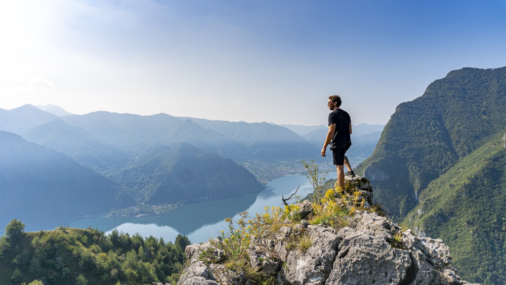 man standing on boulder during daytime