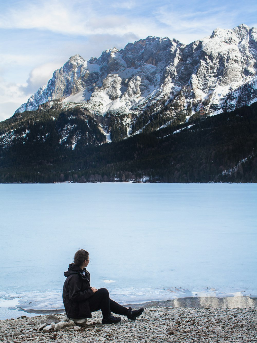 man siting beside body of water