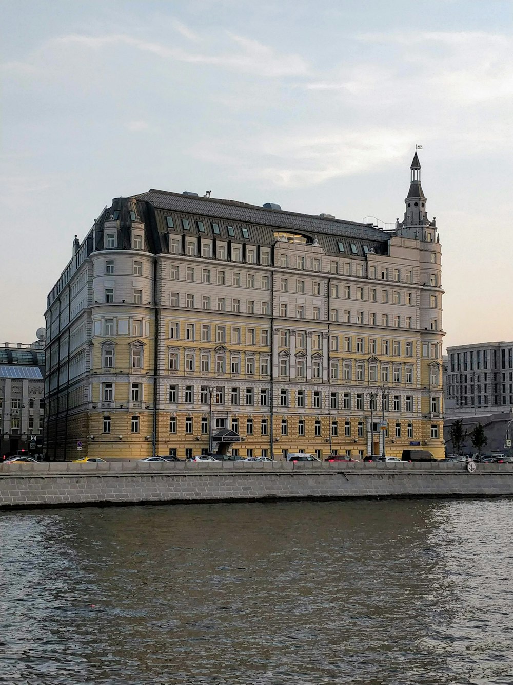 beige and white concrete building near body of water