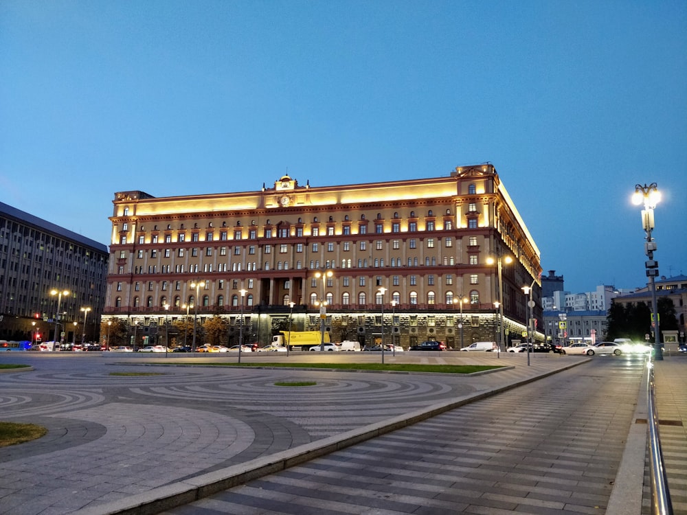 white and beige concrete building with lights near road