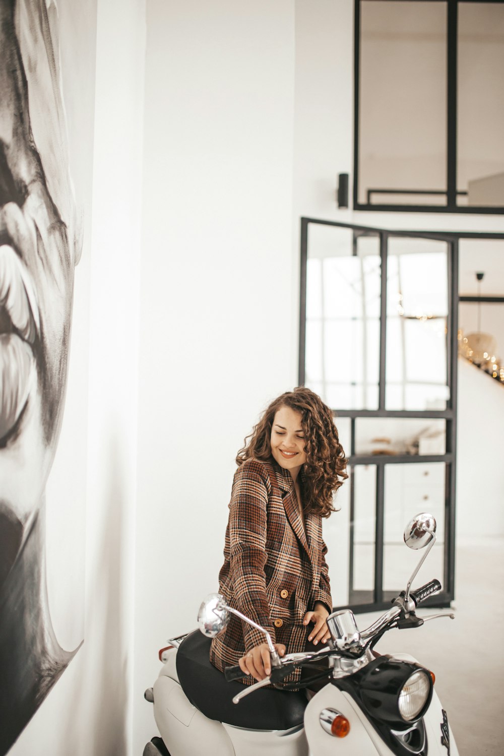 woman riding white motor scooter