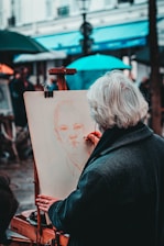 person wearing coat painting man during daytime