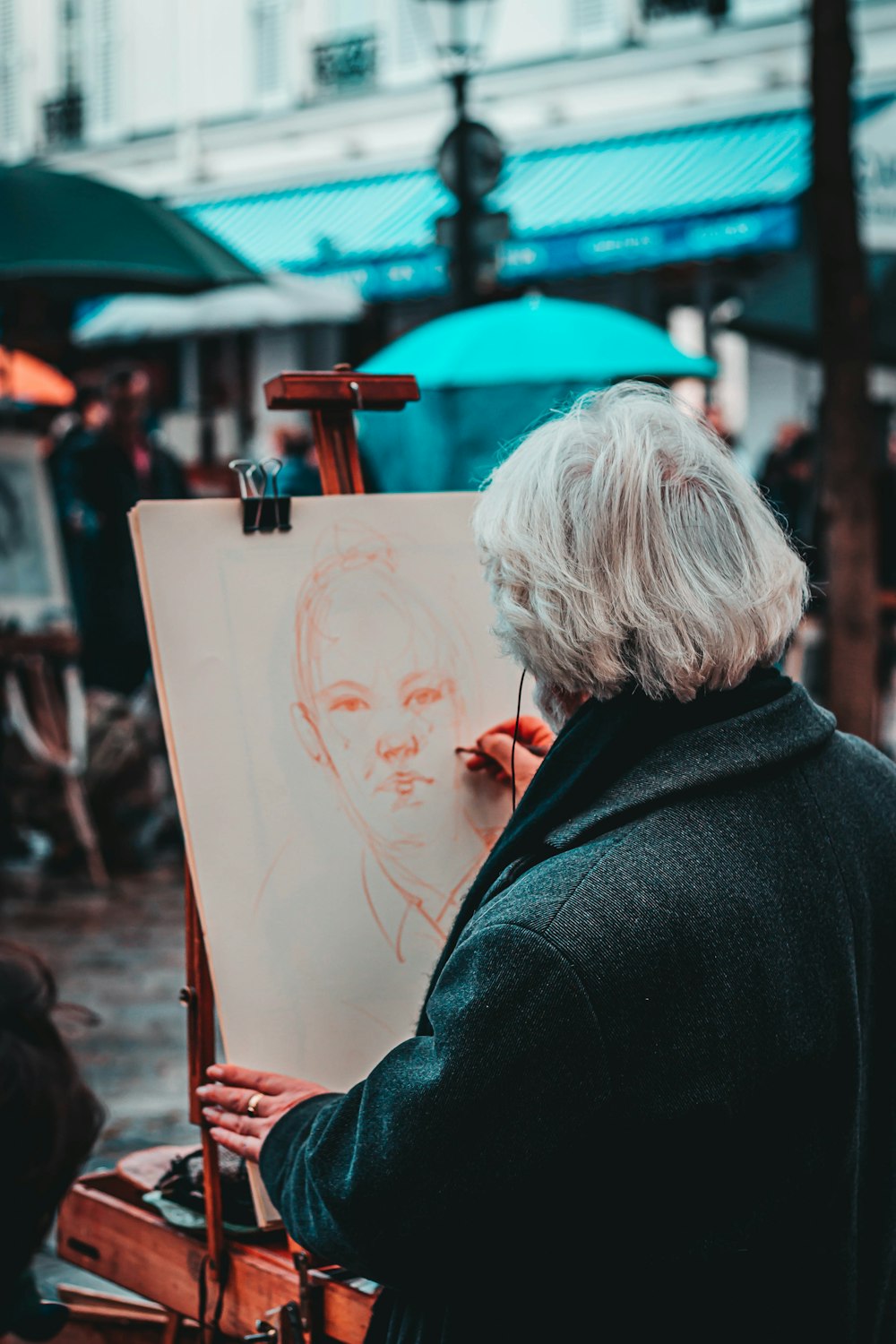 person wearing coat painting man during daytime