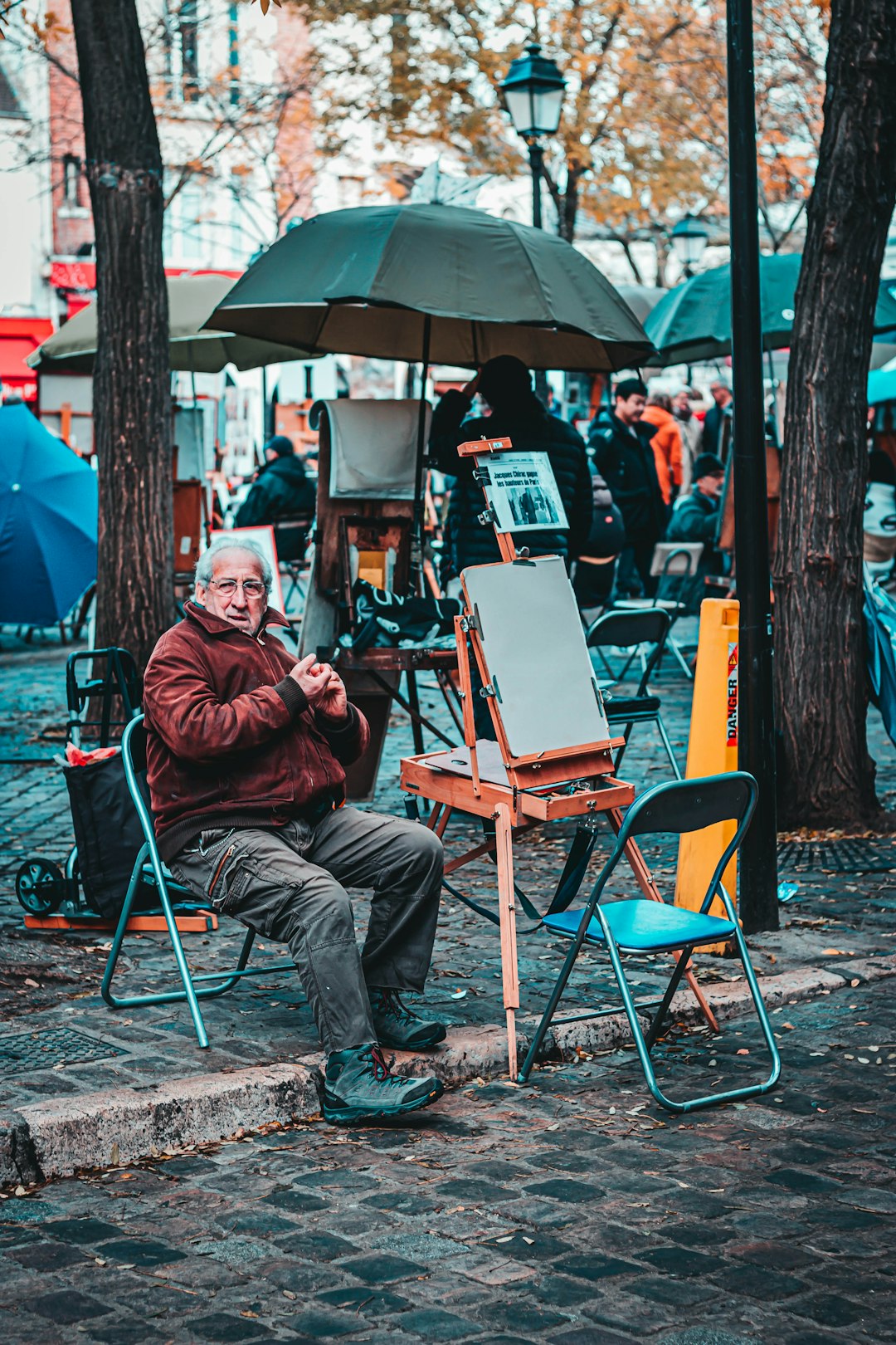 man sitting near the umbrella