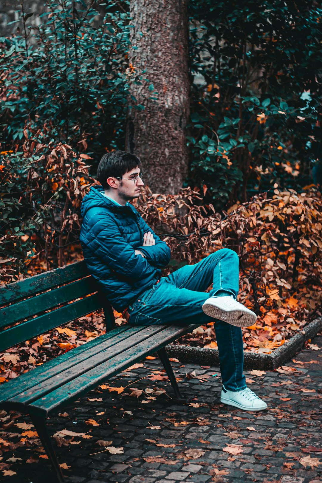 man sitting on wooden bench