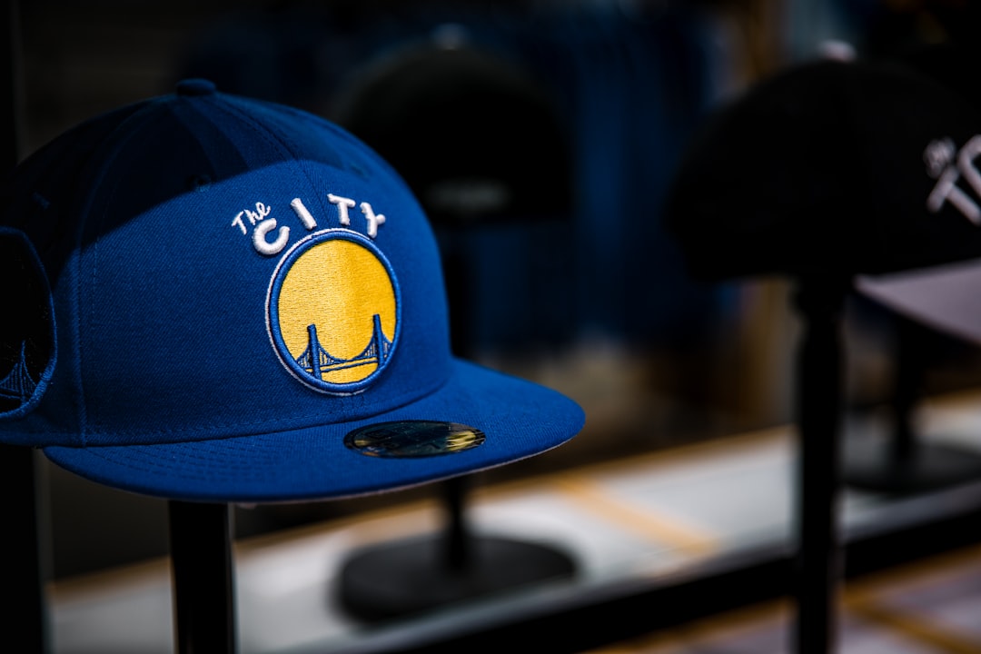 selective focus photography of blue Golden State Warriors The City cap